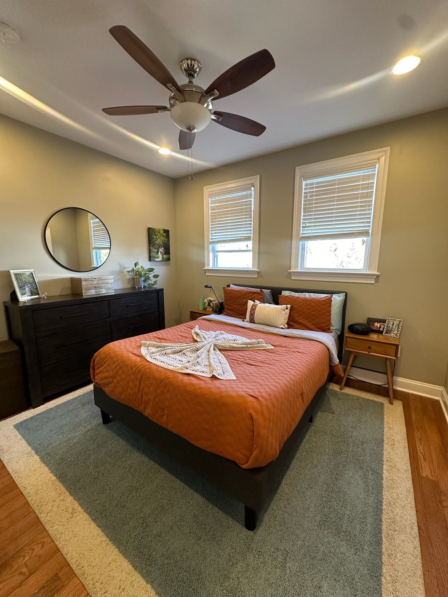 Bedroom with Orange Bedding and Ceiling Fan