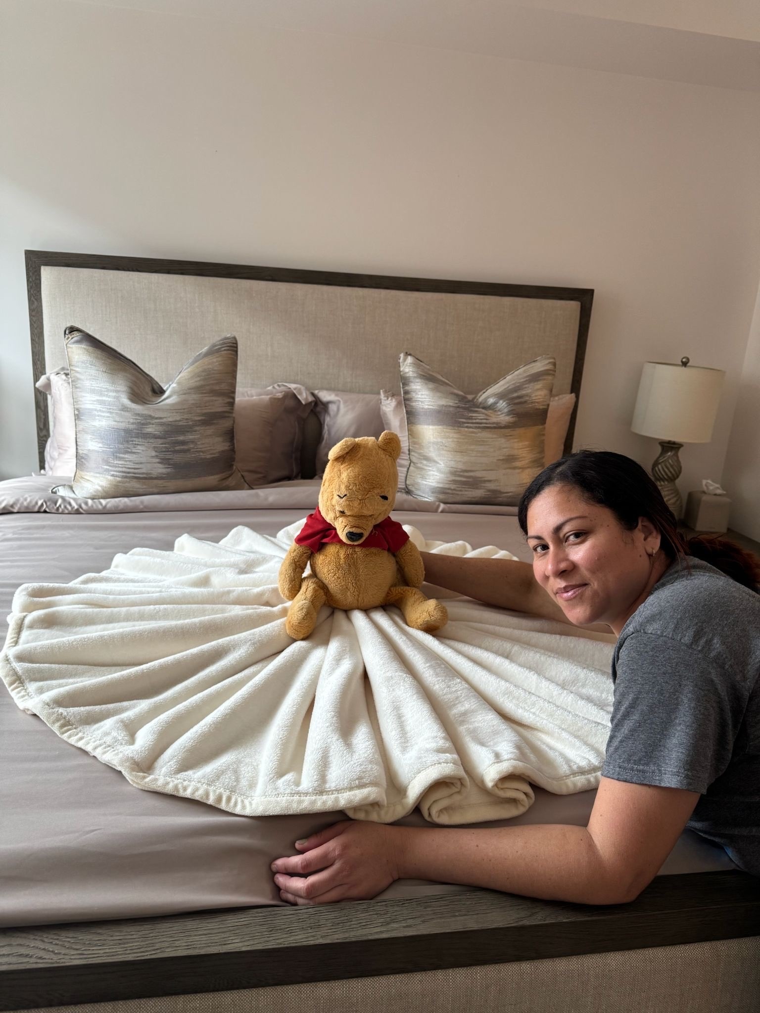 Employee with Winnie the Pooh Plush on a Bed