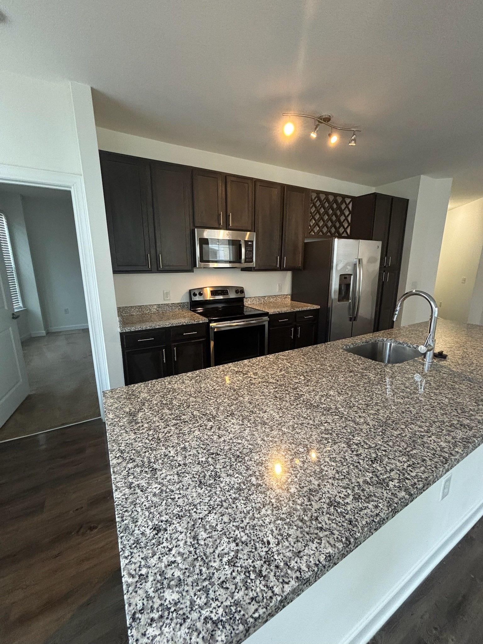 Kitchen with Dark Cabinets and Granite Countertops