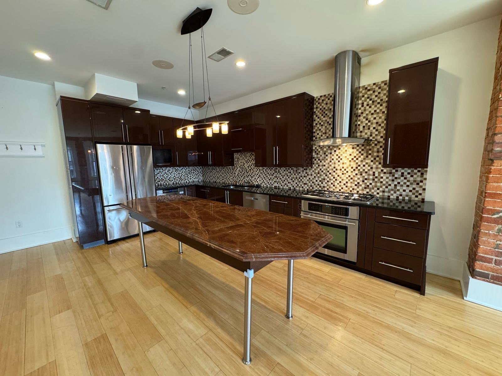 Modern Kitchen with Dark Brown Cabinets and Large Island