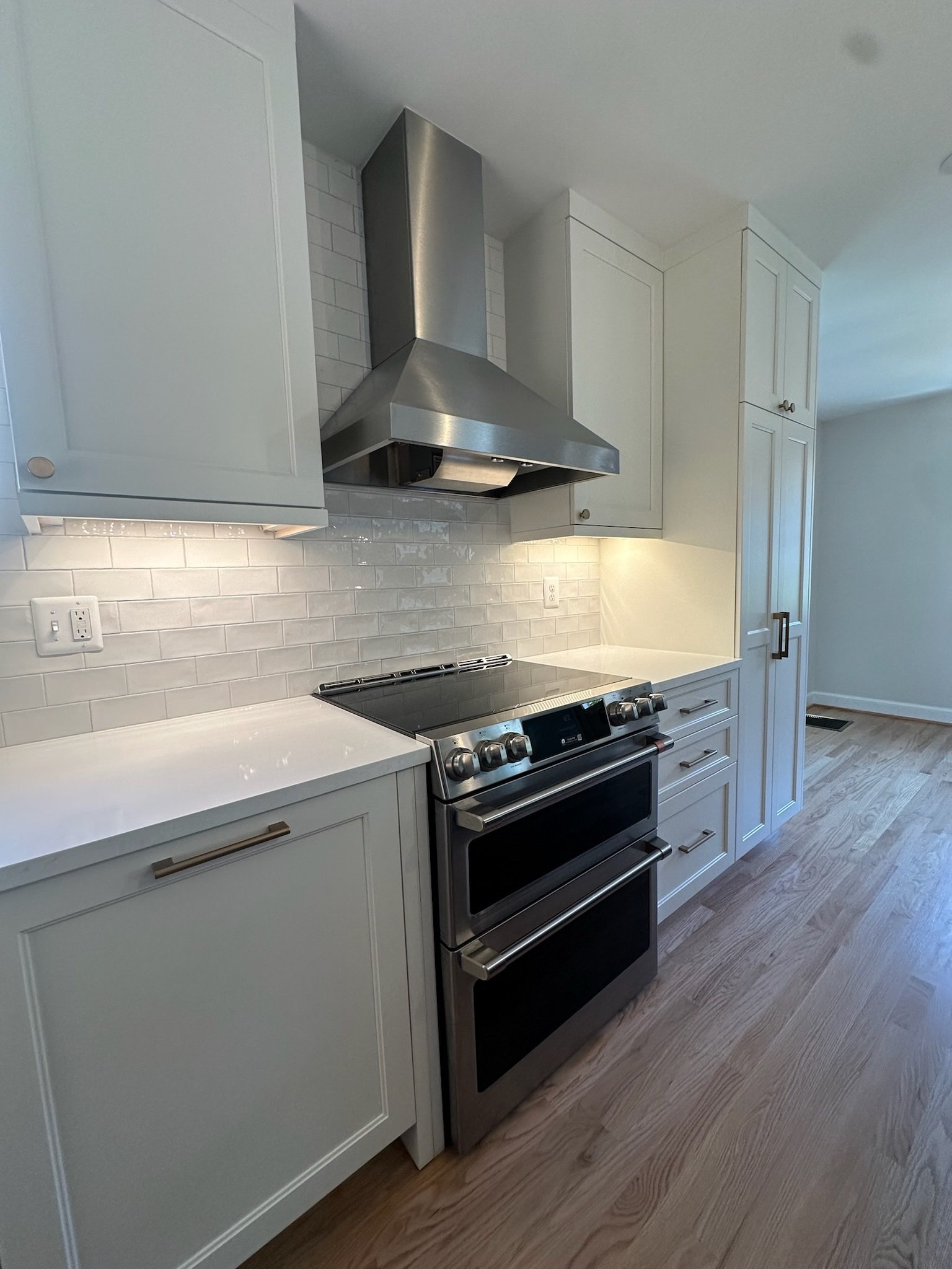 Close-up of Clean Kitchen Stove and White Cabinets